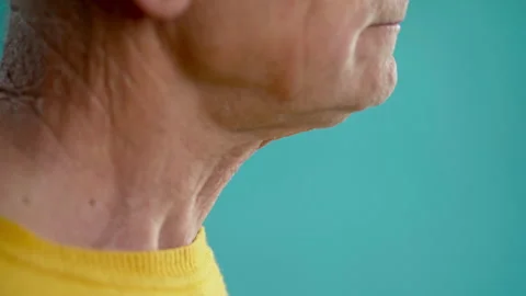Side view of an old man swallowing food, throat and larynx close up Stock Footage 273815724