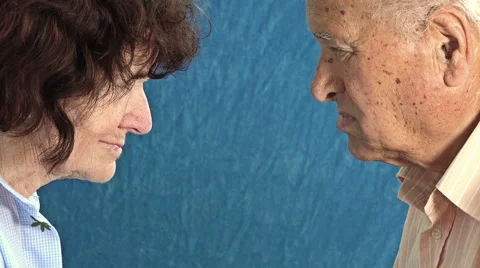 Side view of old married couple looking each other: old lovers portrait Stock Footage 64231013