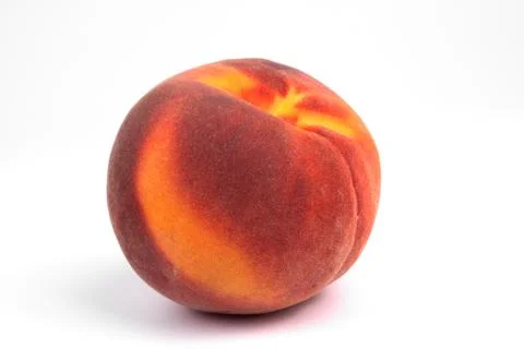 Side view on one red and orange peach laying on white background Stock Photos