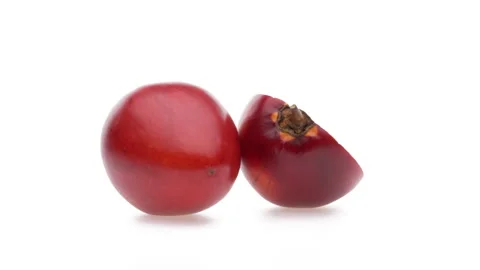 Side view of one whole and one halved tamarillo fruit rotating. Isolated on Stock Footage 161029257