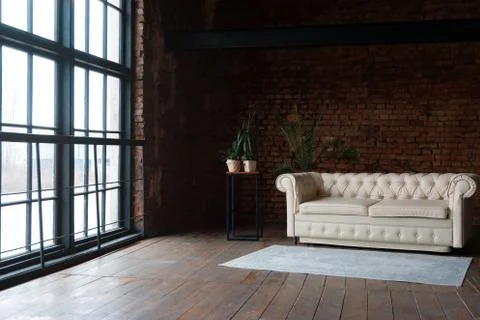 Side view on an open space loft interior with big windows filled with sunligh Stock Photos