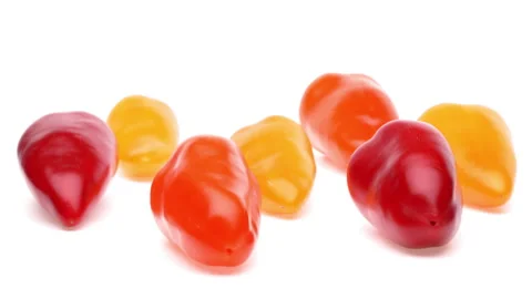 Side view of orange, yellow and red bell peppers rotating. Isolated on white Stock Footage 159157514
