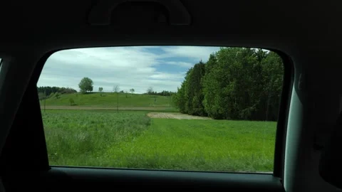 Side view outside a backseat window in a stop and go car drive. Video stock 155068356