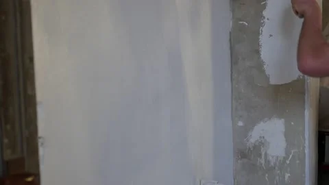 Side view of painter man painting the wall, with paint roller and bucket, Stock Footage 145795529