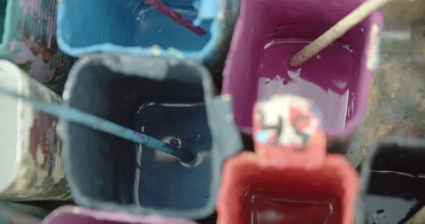 Side view of painting a mural on a wall with brush and roller and palette. Video stock 141754302