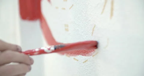 Side view of painting a mural on a wall with brush and roller and palette. Video stock 141756972