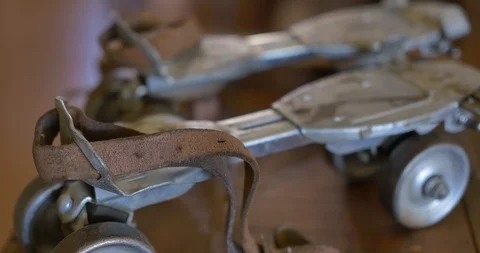 The side view of a pair of extendable antique metal roller skates Stock Footage 120216406