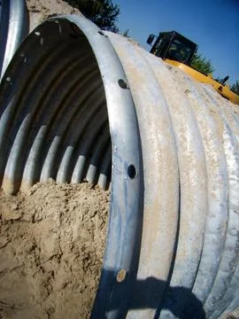 Side view of part of a large drainage pipe at a construction site Stock Photos