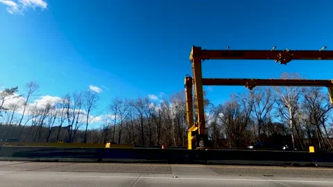 Side view partial massive yellow road construction machine where a new bridge Stock Footage 152170992