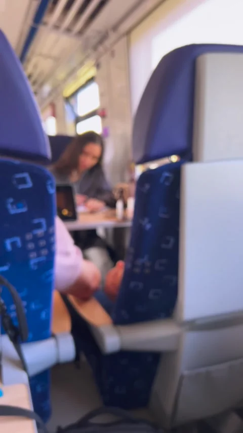 Side view of passengers sitting in comfortable seats during a train ride. 库存影片 346791377