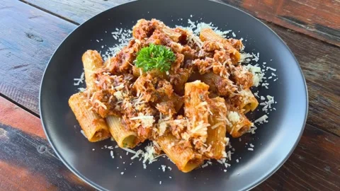 Side view of Pasta. tomato sauce, parmesan cheese, minced pork with rigaton.. Stock Footage 324960697