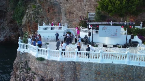 Side view of people after wedding ceremony on the cliff. Groom and bride accept Stock Footage 201216267