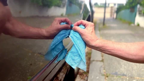 Side view of person cleaning parked car vehicle with blue cloth with reflection Stock Footage 340225674