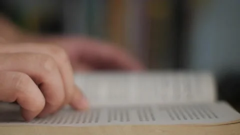 Side view of a person hand touching page when reading a book Video stock 231390908