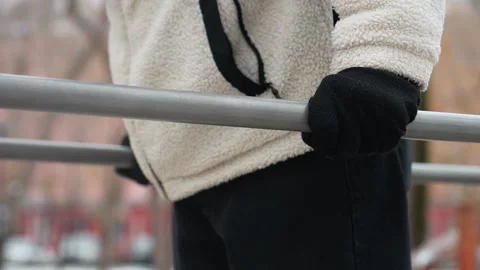 Side View Person in White Winter Jacket Doing Push-Ups with Blurred Winter Video stock 305628899