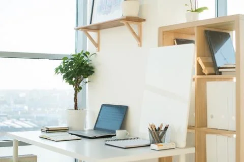 Side view picture of studio workplace with blank notebook, laptop. Designer Stock-Fotos