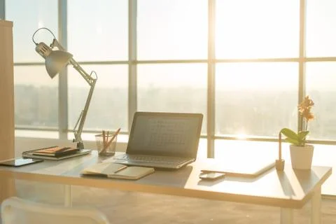 Side view picture of studio workplace with blank notebook, laptop. Comfortable Stock Photos