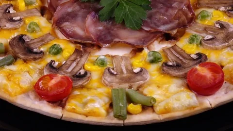 Side view of pizza with ham, mushroom, cheese, green beans and tomatoes close up Stock Footage 84113796