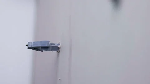 Side view of plasterboard with screwing plastic dowel, fastener dowel with Stock-Footage 302099846