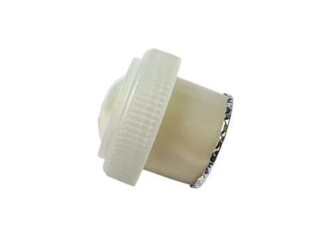Side view of a plastic dispensing cap with a protective membrane Fotos Stock