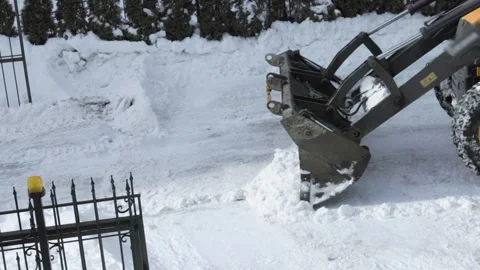 Side View of Plow Blade Moving Deep Snow Across Driveway Stock Footage 347884682