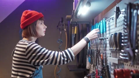Side-view portrait of attractive cute caucasian girl working as mechanic picking Stock Footage 232867853