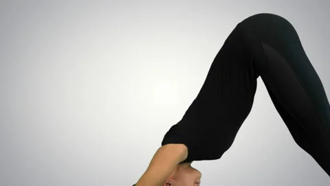 Side view portrait of beautiful young woman doing yoga or pilates exercise. One Vidéo 90363645