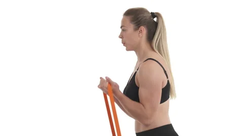 Side view portrait of biceps workout by blond sportswoman with resistance loop Stock Footage 134192323