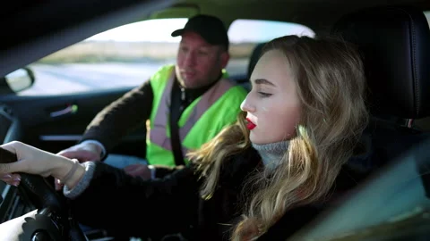 Side view portrait of confident beautiful woman sitting on driver's seat talking Video stock 148750950