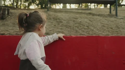 Side view portrait of cute sweet adorable little baby girl playing and walking Stock Footage 253426930
