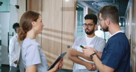 Side view portrait of diverse group of young experienced doctors and nurses Stock Footage 256173482