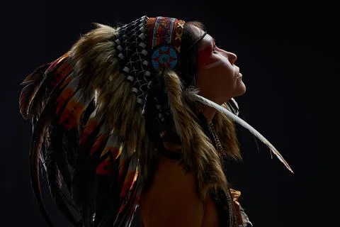 Side view portrait in native american style, beautiful woman in Indian hat Stock Photos