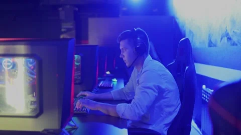 Side view portrait shot of young man with headset winning a shooter game round Stock-Footage 136380539