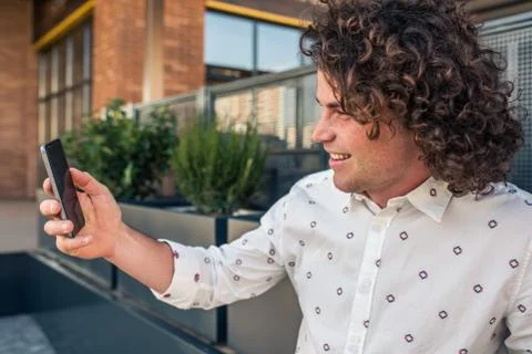 Side view portrait of smiling handsome Caucasian man with freckles in stylish Stock Photos