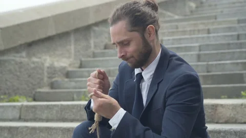 Side view portrait of unhappy businessman holding rope in hands and thinking Stock Footage 140284553