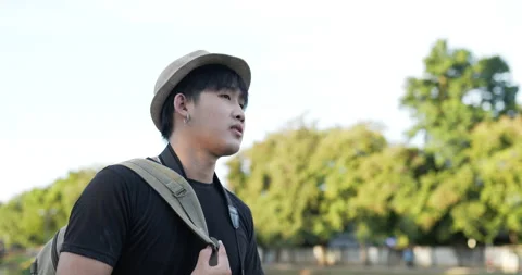 Side view Portrait of Young Asian traveler man with hat walking and resting 스톡 동영상 172461973