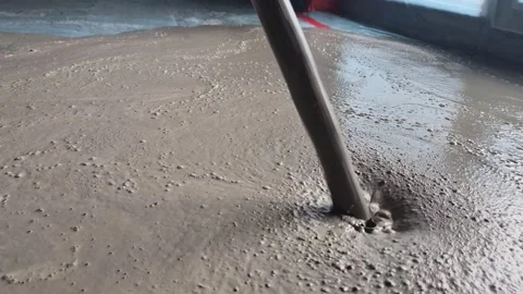 Side View of Pouring Liquid Screed Concrete in New Room Stock Footage 342621367