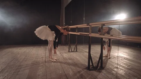 Side view of a pretty young slim ballerina girl warming up Stock Footage 112915879