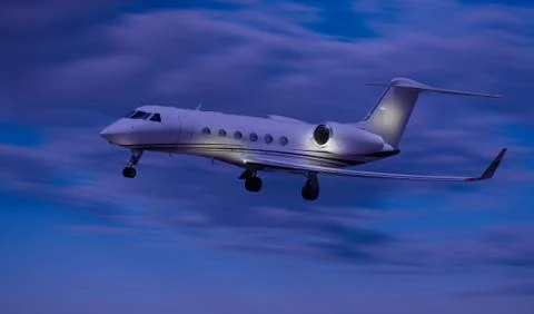 Side view of a private jet flying at night Stock Photos