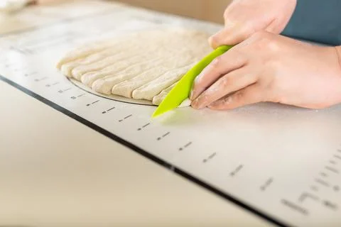 Side view on process of cooking from dough on a baking mat with markings on the Stock Photos