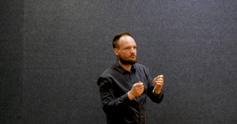 Side view of a professional attractive bearded male playing the triangle  Stock Footage 105921390
