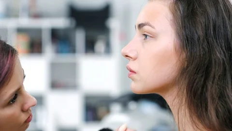 Side view professional female make-up artist making contouring with powder or Stock Footage 93393825