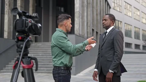 Side view of professional journalist taking interview by handsome politician in Stock Footage 330160556