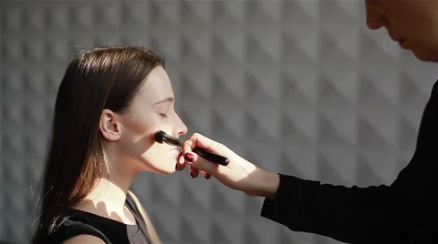 Side view. Professional make-up applying blush on cheekbones. Close-up Stock Footage 54625991