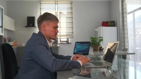 Side view. Programmer reviews and edits app code, suggests optimizations. Stock Footage 299892246
