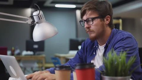 Side view of programmer working on computer in office Stock Footage 121772815