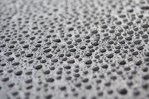 Side view of rain water drop on dark background Stock Photos