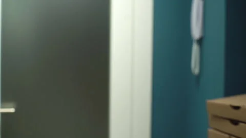 Side view of receiving boxes with hot pizza at home from delivery man on Stock-Footage 146593257