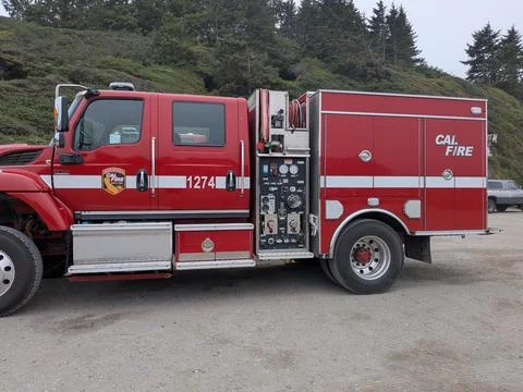 Side view of a red CAL FIRE engine truck parked outdoors 스톡 사진