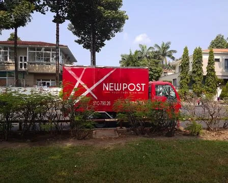 Side view of red mail delivery truck on the street Stock Photos